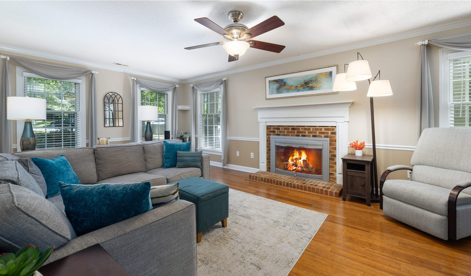 Couple sitting together on couch looking at laptop