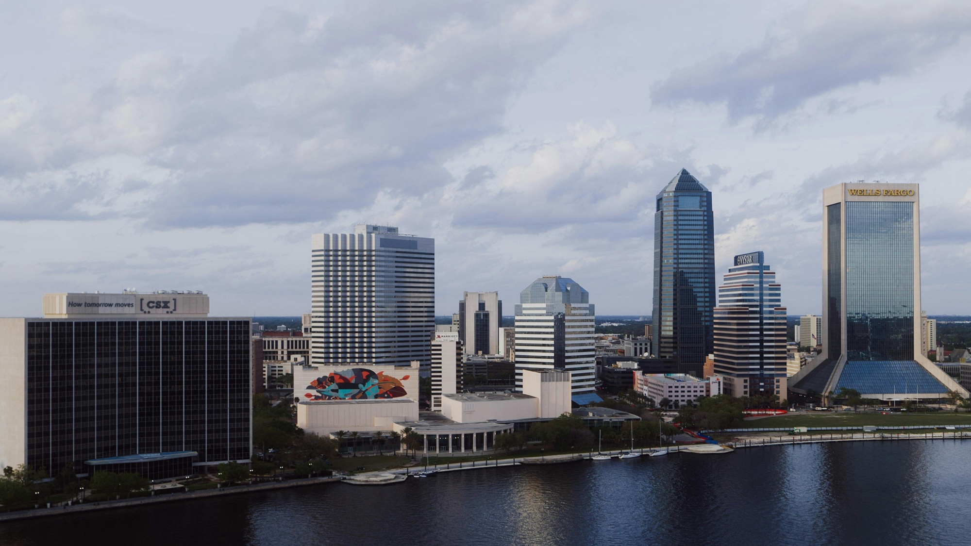Couple sitting together on couch looking at laptop