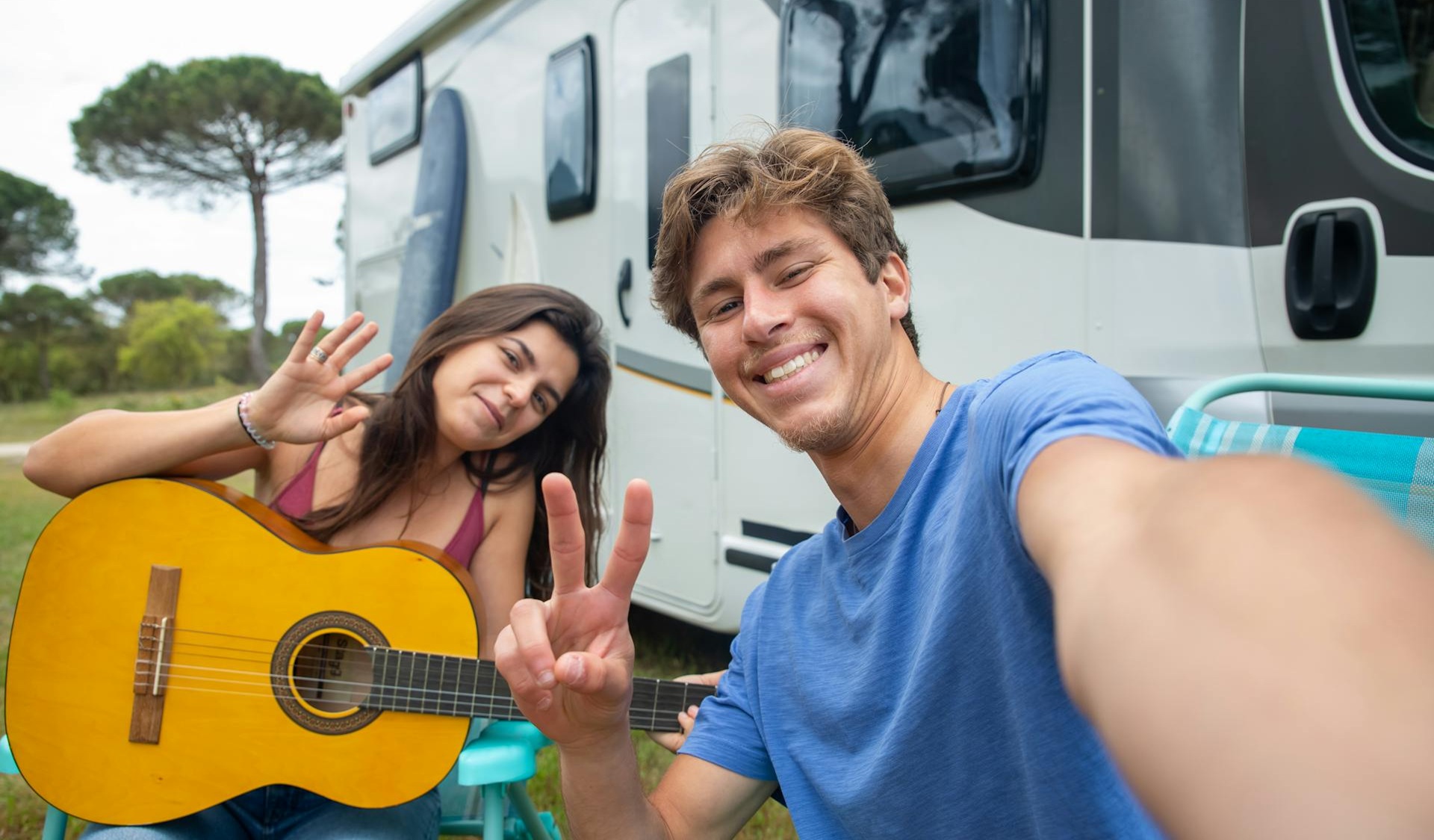 Couple sitting together on couch looking at laptop